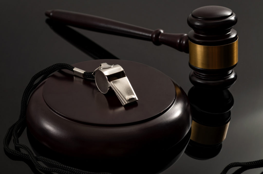 Gavel and whistle symbolizing whistleblower claims, legal enforcement, and data-driven legal document analysis for defensible outcomes