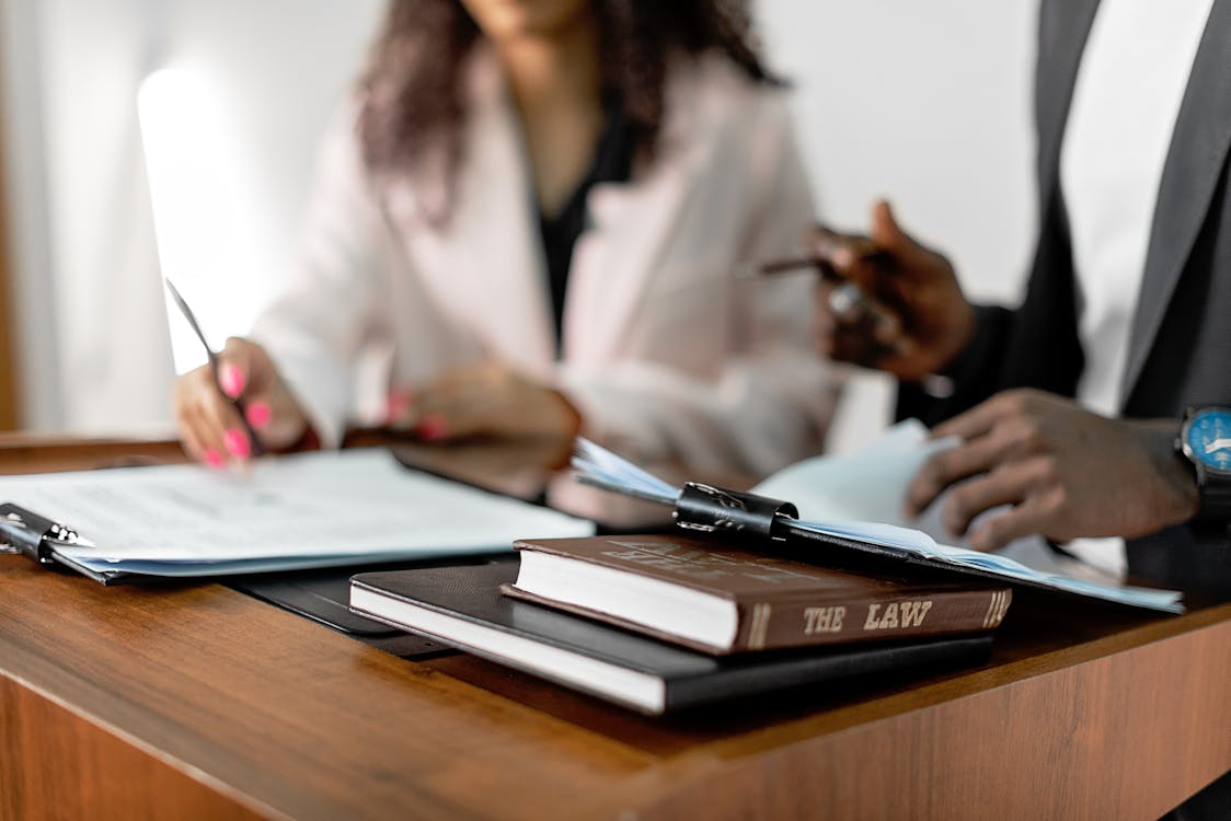 Legal professionals reviewing documents to build defensible whistleblower case using data discovery platform and legal document analysis